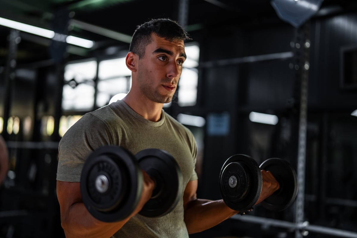 Athlete strength training in a dark gym, monochrome