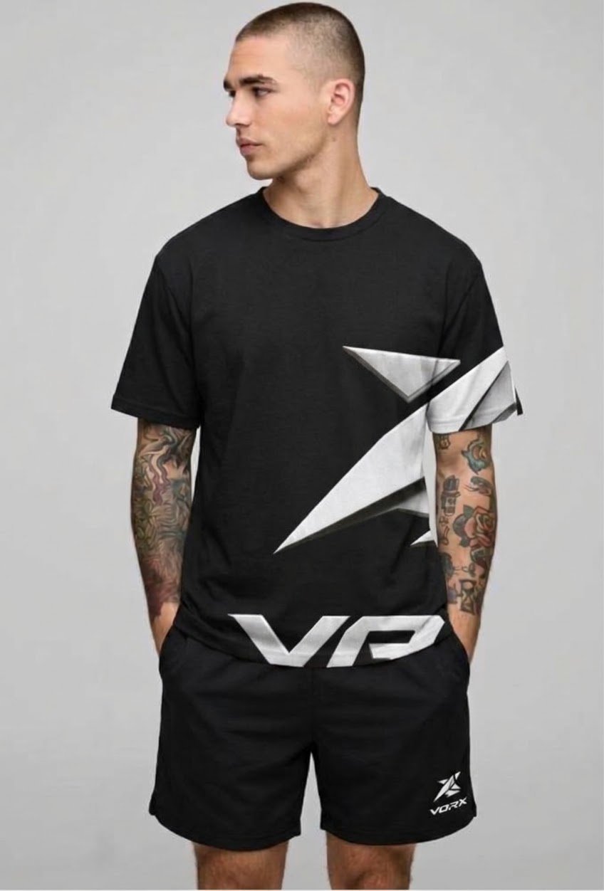 Man wearing black t-shirt and shorts with geometric logo design and tattoos on arms
